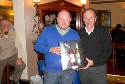 Who's that guzzling pints in the background?
The winner of Class 1 John Fitzgerald getting his prize from Captain Jonathan Smith
