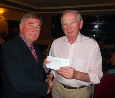 President Jim Murray presents his prize for nearest the pin in 2 to Con McDonald
