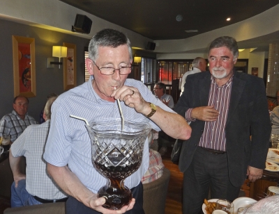 Captain Noel Murray
Noel on the opposite side of the bar for a change as he helps empty the Cider Cup, but was there any left for the patiently waiting Jim Murray?
